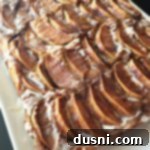 Traditional German Apple Kuchen 16 Apple Kuchen (German Apple Cake) on a white serving plate