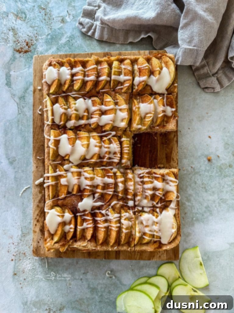 Traditional German Apple Kuchen 3 A slice of German Apple Kuchen on a plate, showcasing the apple layer and cake base.