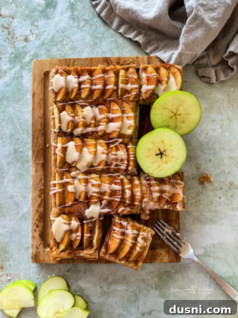Traditional German Apple Kuchen 5 Close-up of baked Apple Kuchen before glazing, showing apple slices and cinnamon sugar.