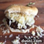 Hearty Brat Burgers 9 close up of a Brat Burger on a table, ready to be served