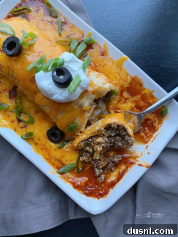 Overhead view of a Copycat Taco Bell Enchirito with a fork taking a bite.