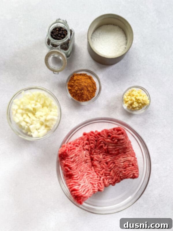 Various fresh ingredients for homemade Mexican Pizza, including ground beef, onions, garlic, and seasoning.