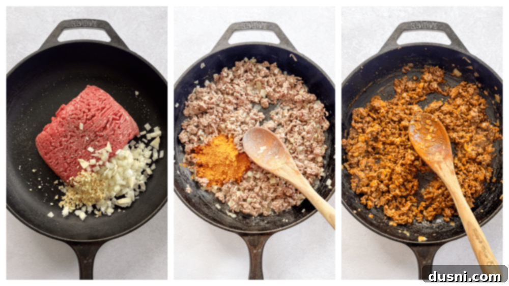 Ground beef cooking in a skillet with onions and garlic.