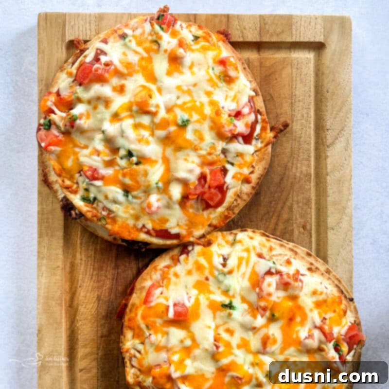 A stack of golden-brown Mexican Pizza slices on a serving platter.