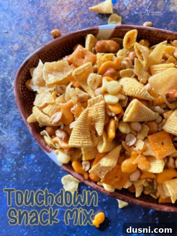 A bowl of Touchdown Snack Mix with a football-themed background, ready for game day.