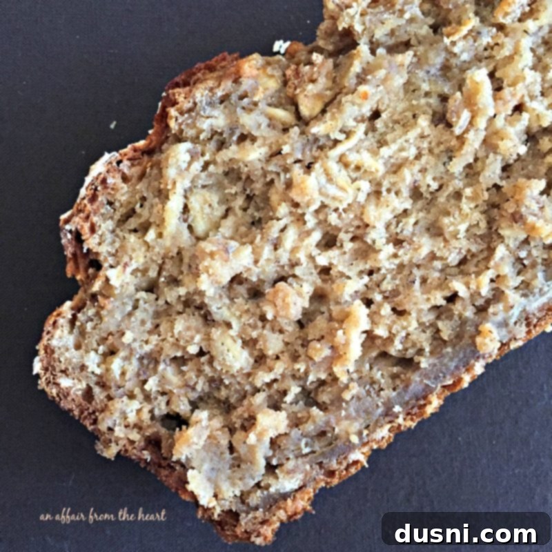 Harvest Banana Oat Loaf 4 Homemade Banana Applesauce Oatmeal Bread cooling on a wire rack, still in the loaf pan