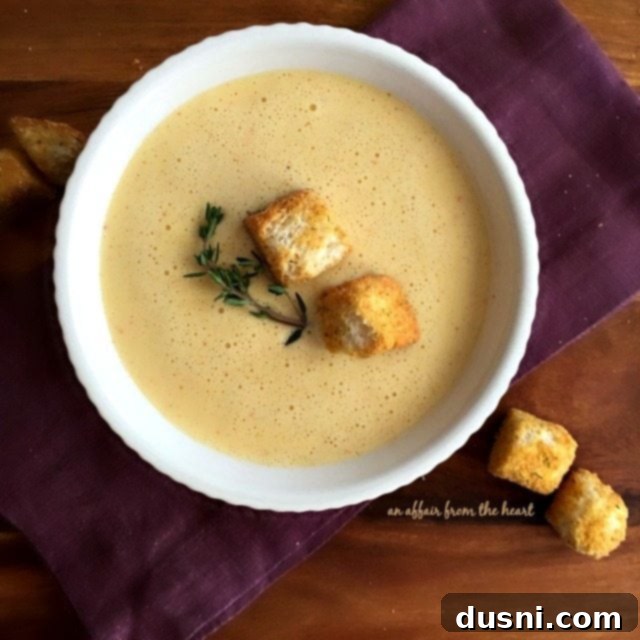 A bowl of the highly-rated 1886 Cafe & Bakery Cheese Soup from The Driskill Hotel, showcasing its creamy texture