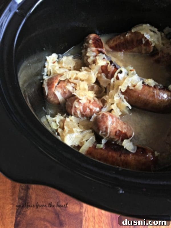Reuben Brats: Slow-Cooked, Savory, Sensational 5 Brats, sauerkraut, onions, and beer simmering in a slow cooker