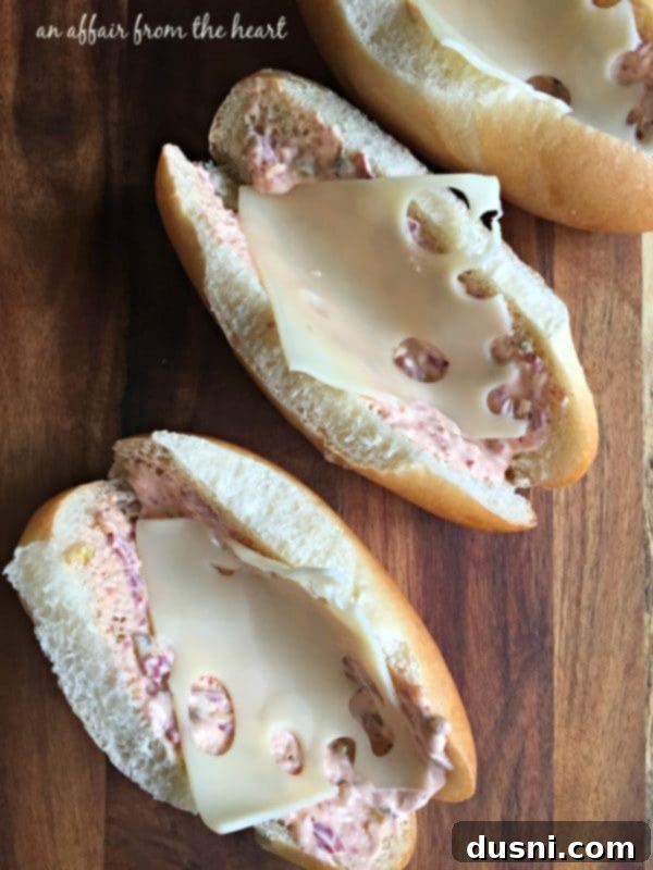 Reuben Brats: Slow-Cooked, Savory, Sensational 8 Assembling a Slow Cooked Reuben Style Brat sandwich with Swiss cheese, bratwurst, and sauerkraut on a hoagie roll