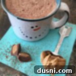 Liquid Peanut Butter Cup 9 Hot cocoa, a spoon with peanut butter with text "Peanut Butter Hot Cocoa"