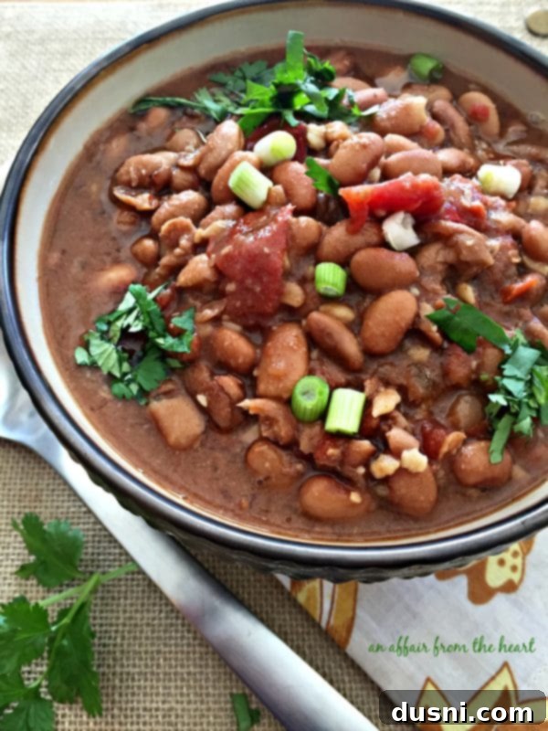 Southwestern Pinto Bean Soup - A large pot of simmering bean soup in a slow cooker, ready to be served.