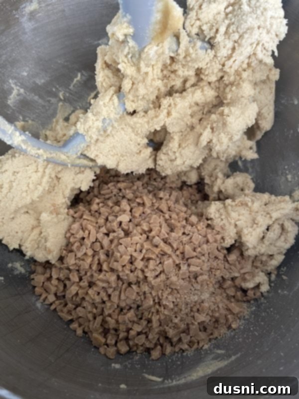 Golden Toffee Crunch Cookies 8 A bowl filled with Heath English Toffee Bits 'O Brickle, ready to be incorporated into the cookie dough