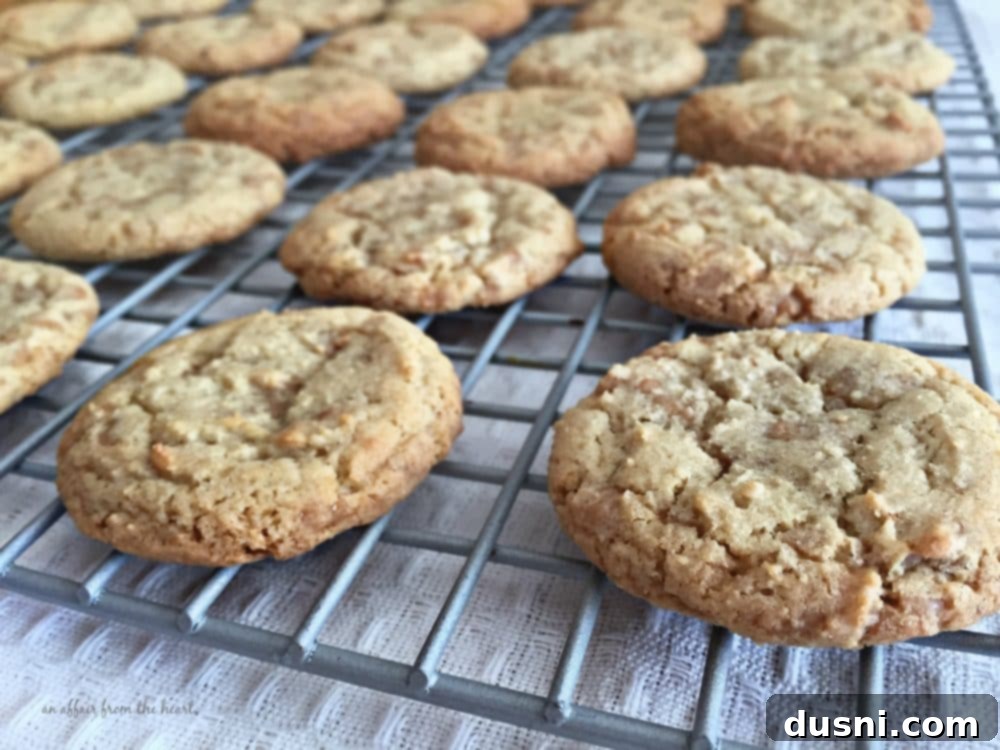 Golden Toffee Crunch Cookies 10 Freshly baked Butter Brickle Cookies cooling on a baking sheet, displaying their golden edges