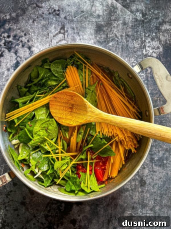A large stockpot with all ingredients for Italian Wonderpot Pasta added and ready to be cooked.