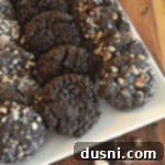 Dark Chocolate Molasses Cookies layered on a white serving tray