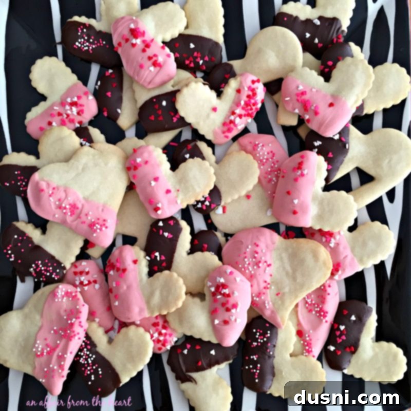 Elegant Dipped Shortbread Cookies, partially covered in chocolate and decorated with festive sprinkles, ideal for Valentine's Day gifting or a romantic tea party.