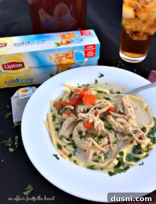 Serving bowl of Spicy Chicken Noodle Soup with fresh cilantro garnish