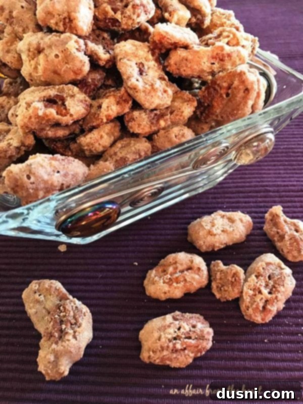 Candied Pecans 2 A bowl overflowing with golden-brown sugared pecans, lightly coated and glistening with sweetness.