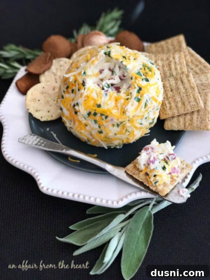 The Ultimate Summer Sausage Cheese Ball 2 Delicious Summer Sausage Cheese Ball served with crackers on a rustic wooden board.