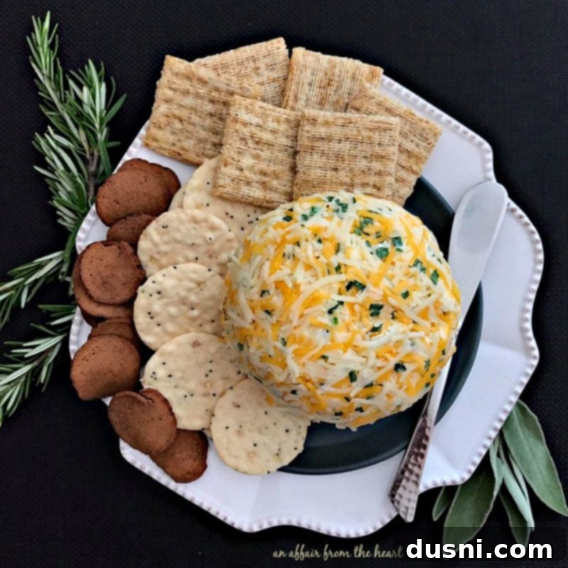 The Ultimate Summer Sausage Cheese Ball 17 A whole Summer Sausage Cheese Ball with crackers on a white plate, ready to be served.