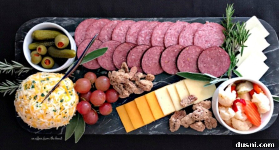 The Ultimate Summer Sausage Cheese Ball 8 Beautifully arranged charcuterie board with sugared pecans, Summer Sausage, and cheeses.