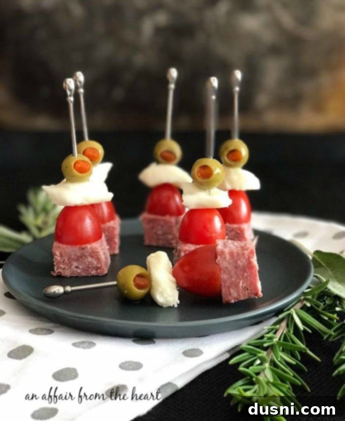 The Ultimate Summer Sausage Cheese Ball 9 Individual Summer Sausage Skewers with cheese and olives.