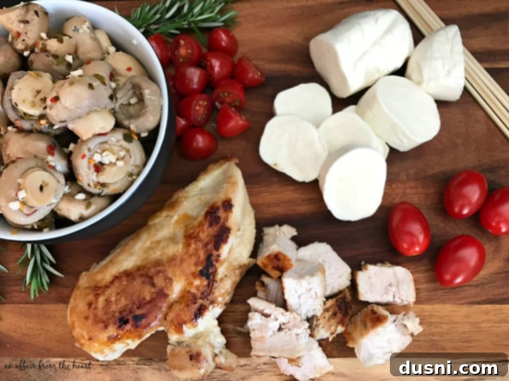 Savory Italian Chicken And Mushroom Starters 5 Ingredients for Italian Chicken & Mushroom Appetizer laid out on a cutting board