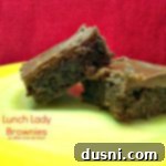 Brownies on a yellow plate with text "lunch lady brownies"