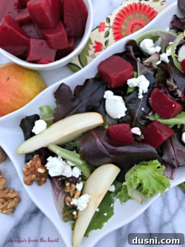 Close-up of a vibrant Pickled Beet Salad with Pears, Walnuts & Goat Cheese