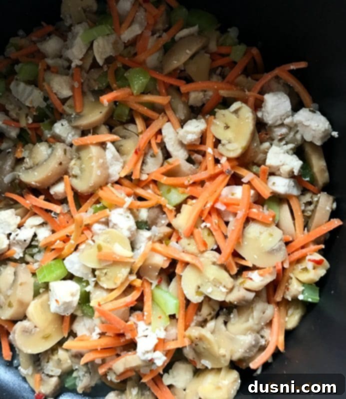 Freshly chopped julienned carrots, celery, mushrooms, and onion laid out, ready for the soup pot.