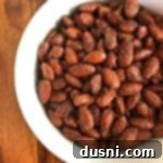 Crispy Spicy Smoked Almonds in a white bowl, ready to serve.