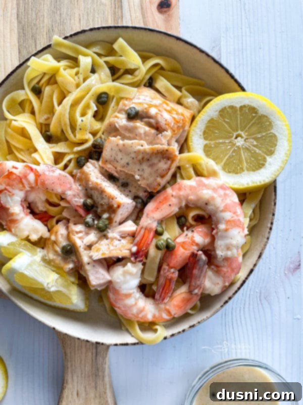 top view of lemon caper sauce over salmon and shrimp