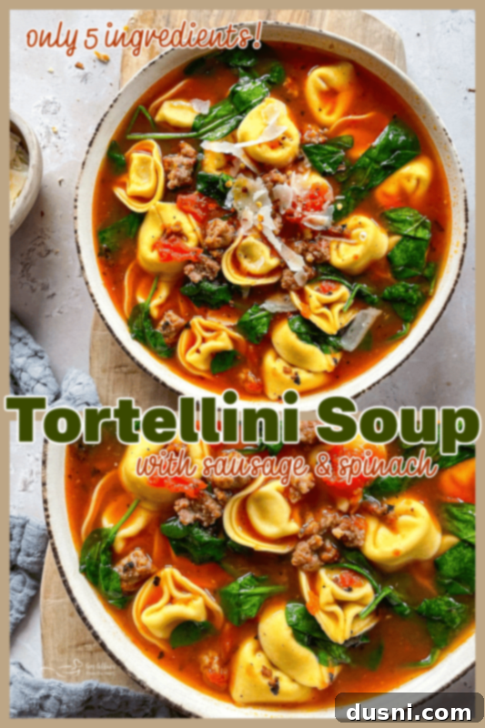 A large pot of freshly made tortellini soup with sausage and spinach, ready to be served