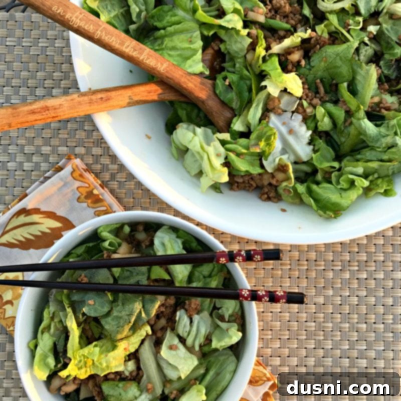 PF Changs Inspired Lettuce Wrap Salad 7 A large, vibrant bowl of homemade PF Chang's Lettuce Wrap Salad, emphasizing the crisp butter lettuce and flavorful chicken mixture.