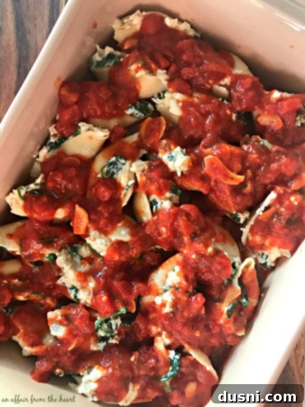 Spinach & Artichoke Stuffed Shells - Stuffed shells in a baking dish.