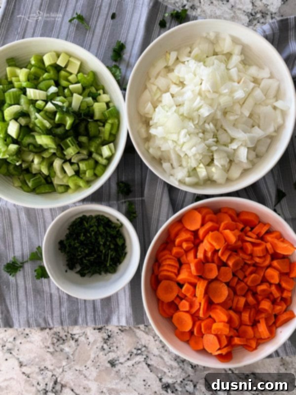 A large pot of simmering hamburger soup, filled with beef, vegetables, and barley