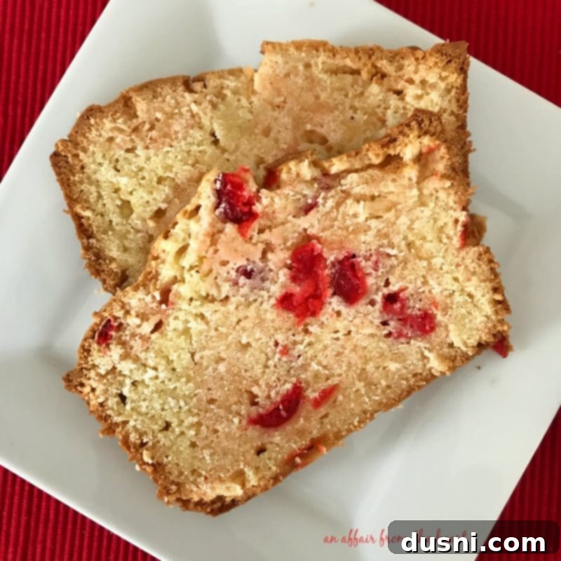 Sweet Cherry Cheese Bread 2 Moist Cherry Cream Cheese Quick Bread sliced on a plate, showcasing its vibrant cherries and soft texture