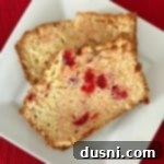 Sweet Cherry Cheese Bread 8 close up of a slices of Cherry Cheese Bread on a white plate