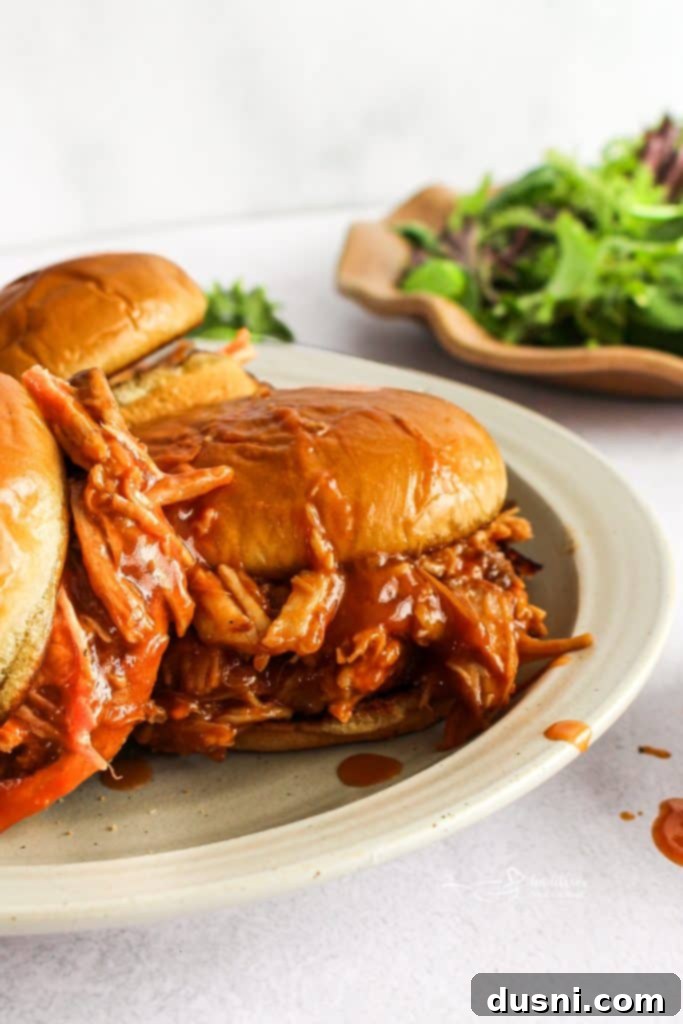 Slow Cooker Dr. Pepper BBQ Pork Sandwiches with side salad