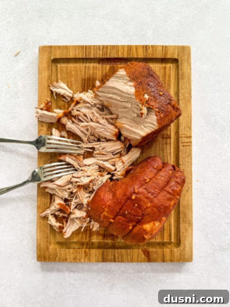 Shredding pork on a cutting board