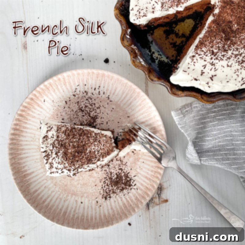 Top-down close-up of a French Silk Pie slice with a fork, emphasizing its silky texture and chocolate curls.