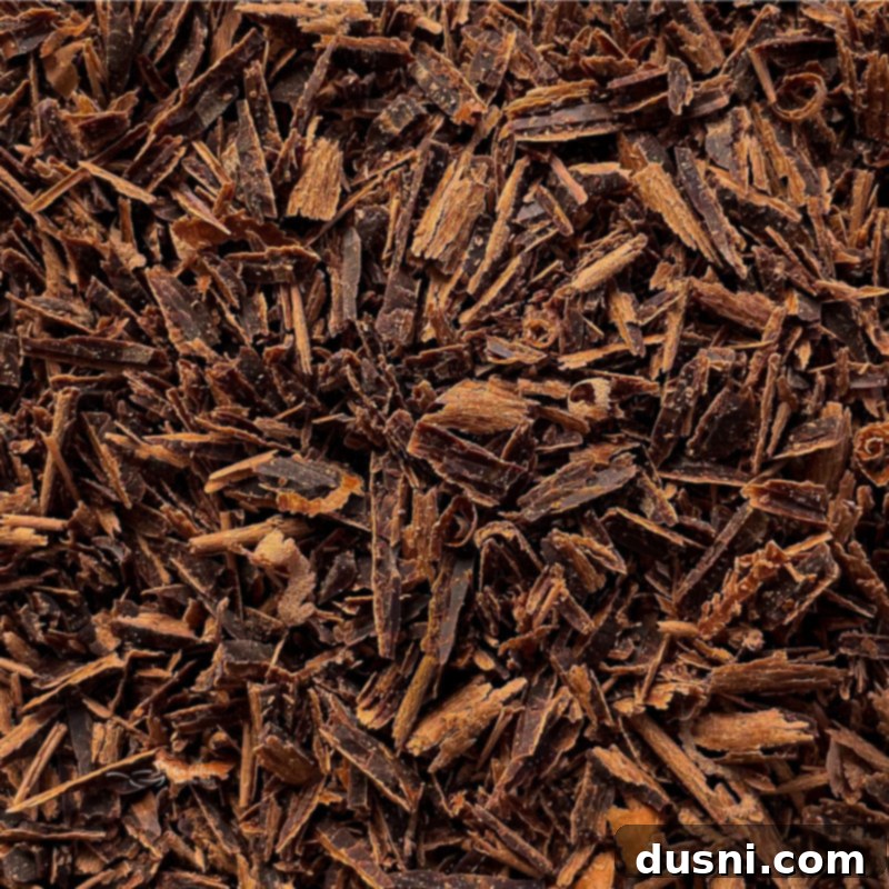 Close-up top view of dark chocolate shavings, ready for garnish.