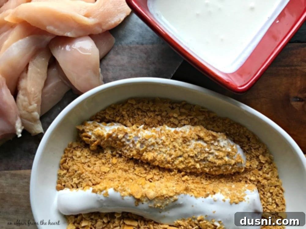 Zesty Oven-Baked Chicken Strips 11 Chicken tenderloin being dipped in buttermilk mixture.