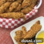 Zesty Oven-Baked Chicken Strips 15 Spicy Baked Chicken Tenders in a basket and on a white plate