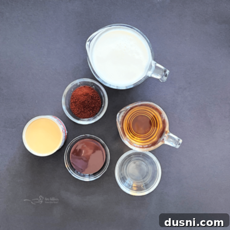 Velvet Homemade Irish Cream 4 Ingredients for Homemade Irish Cream laid out on a table: whiskey, half and half, chocolate syrup, sweetened condensed milk, coconut extract, instant coffee.