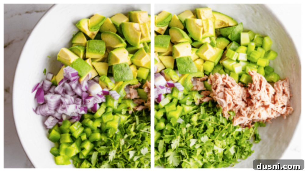 Creamy Avocado Tuna Bliss 7 Olive oil, lemon juice, salt, and pepper being whisked together in a bowl.