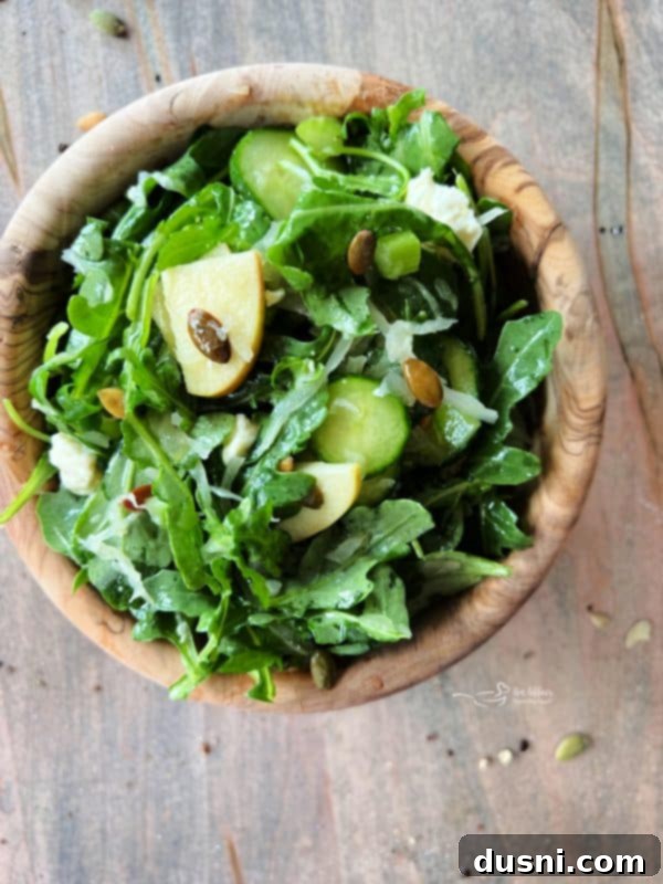 Viral Zest: Arugula Sauerkraut Salad 2 TikTok Sauerkraut Arugula Salad with fresh ingredients in a wooden bowl