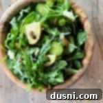 Viral Zest: Arugula Sauerkraut Salad 18 TikTok Sauerkraut Arugula Salad in a wooden bowl.