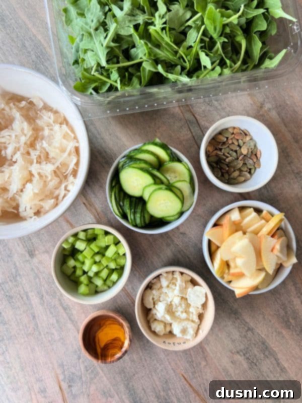 Viral Zest: Arugula Sauerkraut Salad 5 A large wooden bowl filled with the colorful TikTok Sauerkraut Arugula Salad.