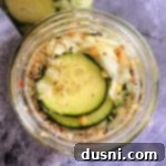 Sweet & Spicy Refrigerator Pickles in a mason jar